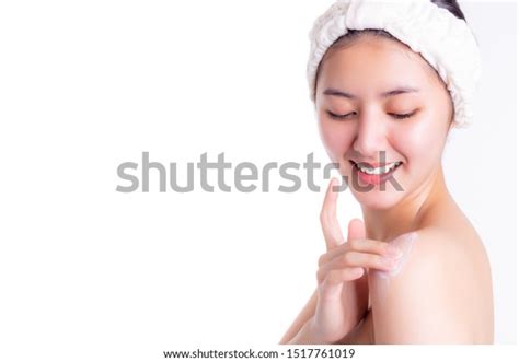 beautiful asian woman applies body lotion to her body everyday when finished bath with smiley