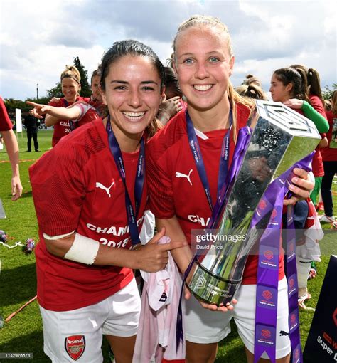 Danielle van de Donk and Beth Mead of Arsenal with the WSL Trophy