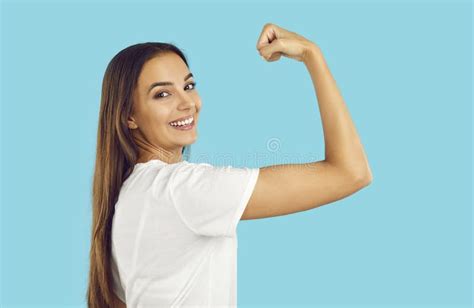 Confident Strong Happy Woman Smiling And Showing Her Power Flexing Arm