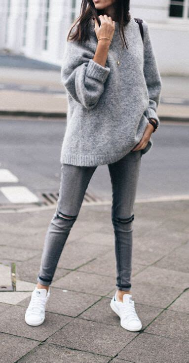 sporty woman in grey skinny jeans and an oversized grey mohair sweater fashion winter fashion