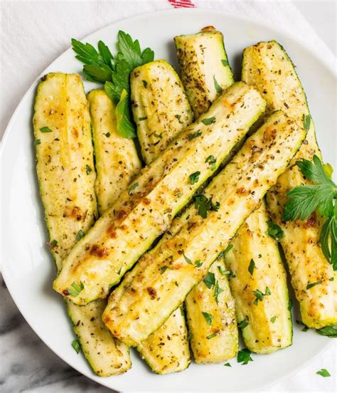 Sliced zucchini and squash are coated in italian seasoning and parmesan cheese then roasted in the oven. Roasted Zucchini - How to Make the BEST Baked Zucchini