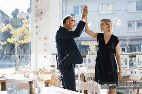 Successful Businessman And Woman High Fiving In A Coffee Shop — Job