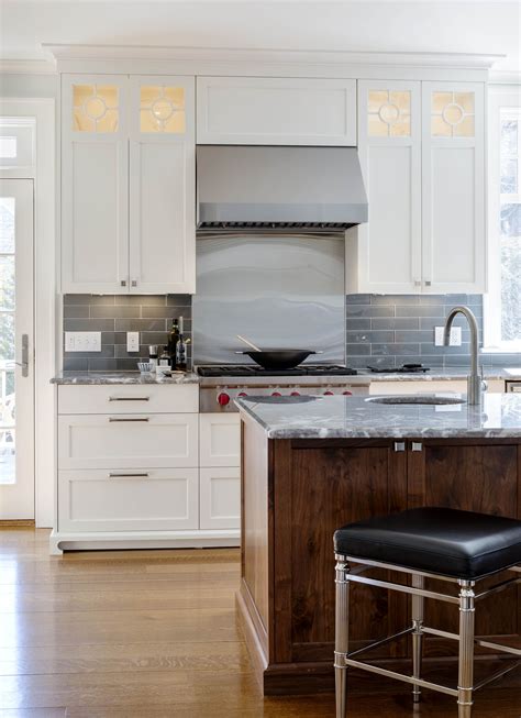A Stainless Steel Backsplash And Range Hood Is Reminiscent Of A