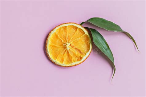 Juicy Orange Slice With Leaves On A Pink Background Sliced Citrus