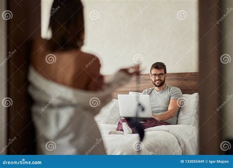 girl seduces a man who works on a laptop for sex in the bedroom stock image image of couple