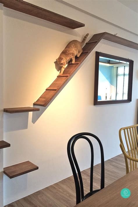 There Is A Cat Sitting On Top Of The Stairs In This Dining Room Table