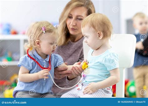 Kids Learning With A Teacher Are A Doctor And Patient Stock Image