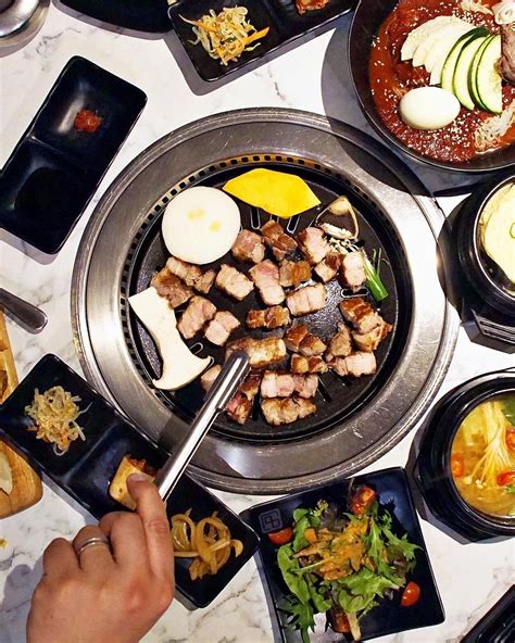 A Table Topped With Lots Of Different Types Of Food On Top Of Metal Pans