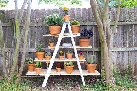 Grab a wooden ladder and hang it from the this white diy plant stand by blackshinythings is an elegant and modern way to decorate the interiors of your home. DIY Tiered Plant Stand From an Old Ladder - Love & Renovations
