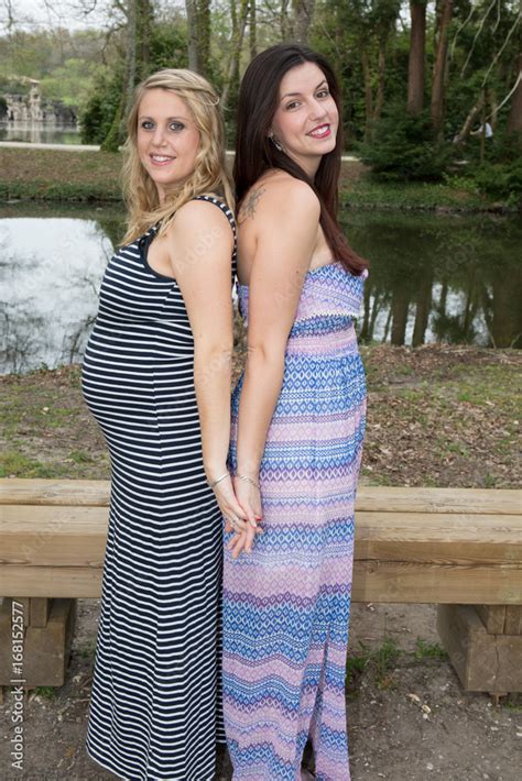 pregnant lesbian couple together outdoors in park stock foto adobe stock