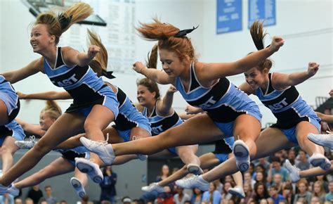 The varsity cheerleaders perform a routine with a series of jumps at
