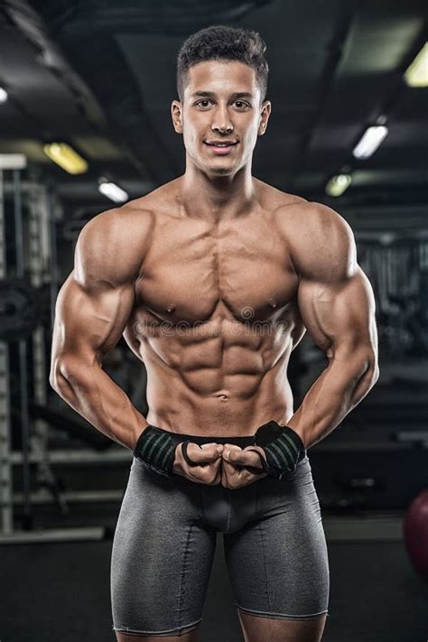 Strong And Handsome Young Man Doing Exercise With Dumbbells Stock Image