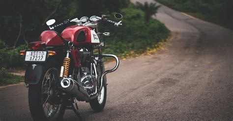 Red Standard Motorcycle Parked On Farm Road · Free Stock Photo