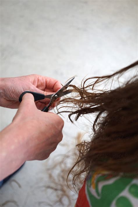 Cutting Hair With A Scissor By Stocksy Contributor Marcel Stocksy