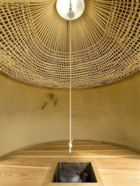 A Room That Has A Ceiling Made Out Of Bamboo Sticks With A Pot In The