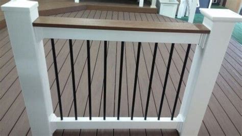 1.5 square spindle vinyl railing. White vinyl deck over railing with black aluminum spindles ...