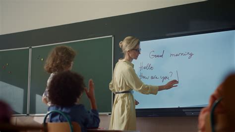 Teacher Using Interactive Digital Whiteboard Student Writing On Smart