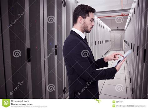 Composite Image Of Concentrated Businessman Touching His Tablet Stock