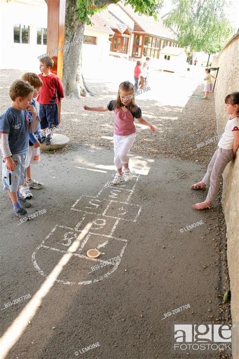 Hopscotch Game Children Playing Hopscotch In The Playground Stock