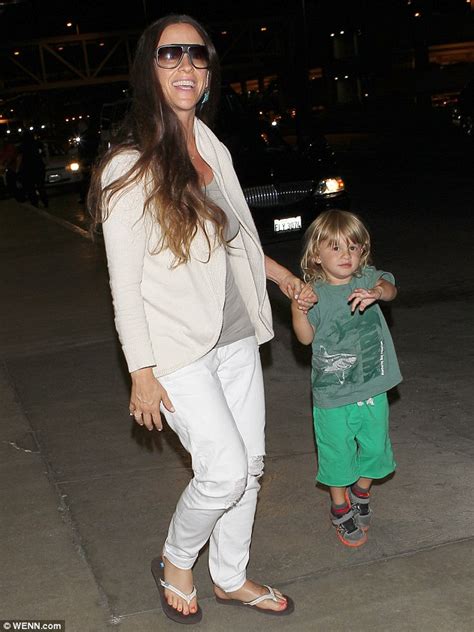 Alanis Morissette Cuddles Her Long Haired Son Ever As They Jet Into La Daily Mail Online