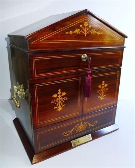 The antique cabinet is constructed of walnut and features a single door that opens to reveal a copper lined interior designed to hold cigars. Magnificent Antique English Inlaid Rosewood Cigar Cabinet ...