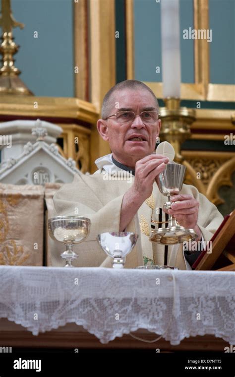 A Catholic Priest Celebrates Mass With The Holy Eucharist And Chalice