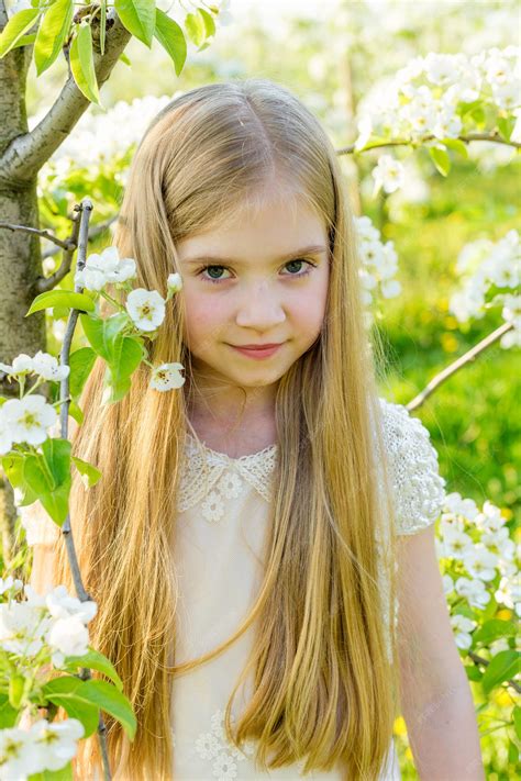 Premium Photo Portrait Of A Girl Among Flowering Trees