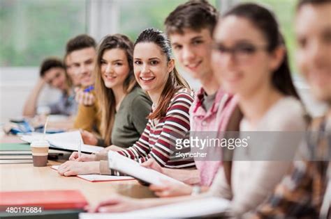 Happy College Students In Classroom Looking At Camera High Res Stock
