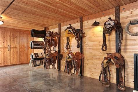The Inside Of A Building With Several Horse Saddles Hanging On The Wall