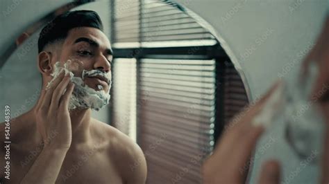 hispanic latina indian bearded male unshaven with bristle millennial man smearing white foam