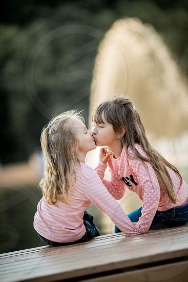 Little Sisters Kissing Portrait Near Sunny Fountain Russia By Julia
