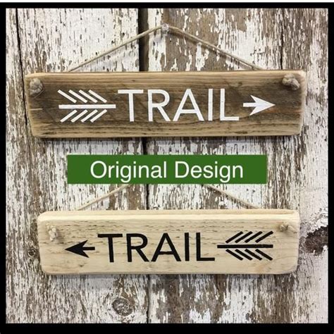 Two Wooden Signs That Say Trail And Original Design