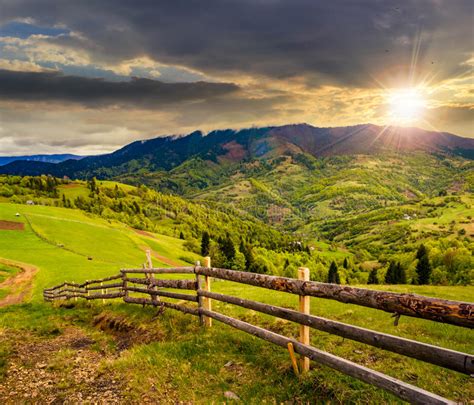 Fence On Hillside Meadow In Mountain At Sunset Stock Image Image Of