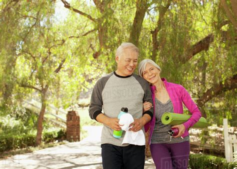 Older couple walking together outdoors - Stock Photo - Dissolve
