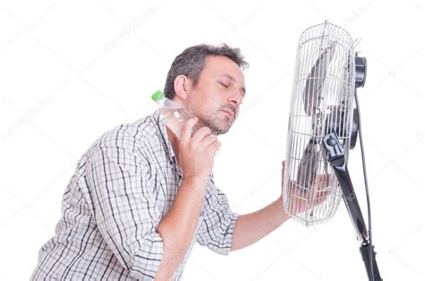 Man Cooling Down In Front Of Blowing Fan Stock Photo By ©catalin205