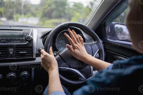 Woman Pushing Horn While Driving Sitting Of A Steering Wheel Press Car