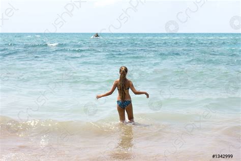 Slim Girl With Long Hair Goes To The Sea By Stock Photo