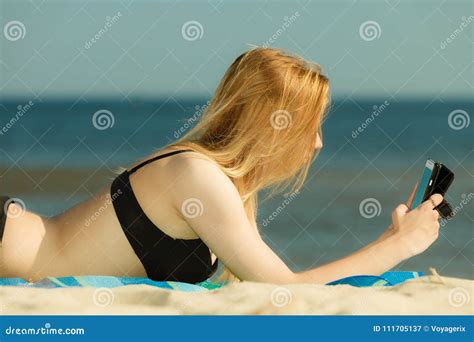 frau im bikini ein sonnenbad nehmend und auf strand entspannend stockbild bild von