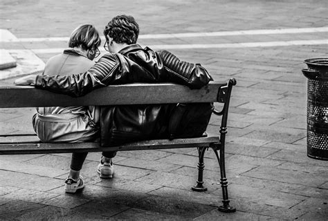 Grayscale Photo Of Two Person Sitting On A Bench · Free Stock Photo