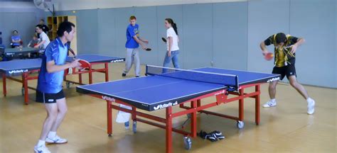 The playing surface is a 9 ft by 5 ft rectangular table (2.7 m by 1.5 m), usually dark blue or green in color. table-tennis - Playo