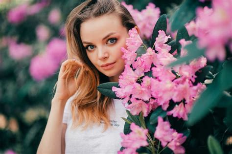 Premium Photo Young Beautiful Girl Posing Among The Flowering Tree