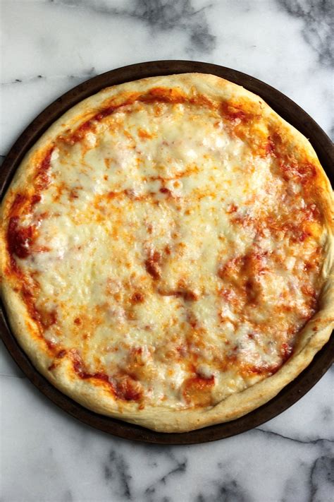 The city's signature massive round pizzas that are sold by the slice typically use bread flour to create a robust dough that can hold up generous toppings. The Best New York Style Cheese Pizza - Baker by Nature