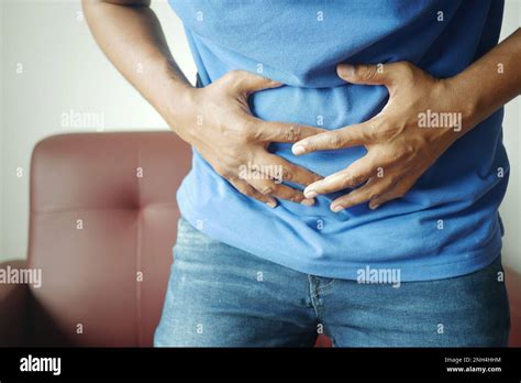 Young Man Suffering Stomach Pain Close Up Stock Photo Alamy