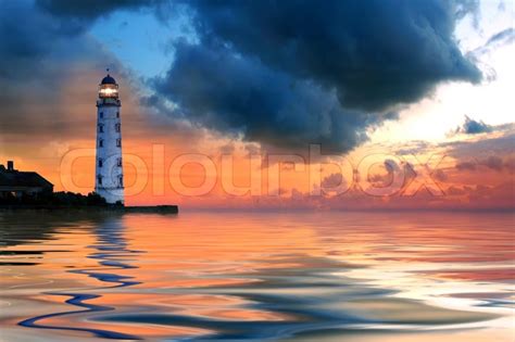 Beautiful Nightly Seascape With Lighthouse And Moody Sky At The Sunset