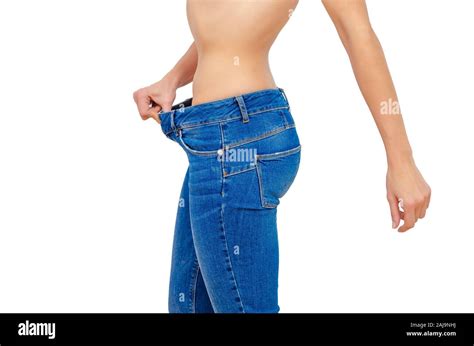 Woman Shows Weight Loss In Old Big Jeans Stock Photo Alamy