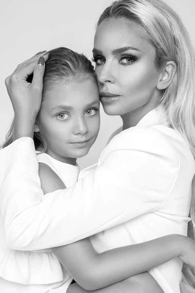beautiful blonde female model mother with blonde daughter hug they have beautiful tanned body