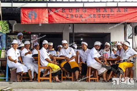 A Group Of Balinese Hindu Men Sitting At A Restaurant Besakih Temple