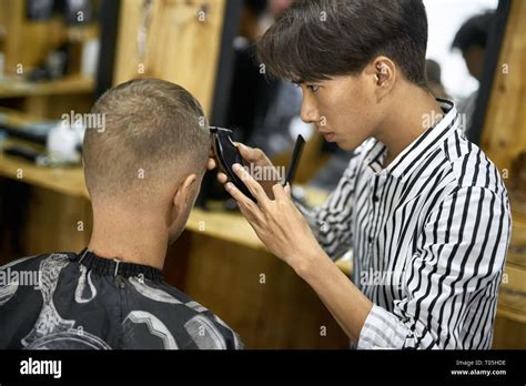 Man is cutting his hair in asian barbershop Stock Photo - Alamy