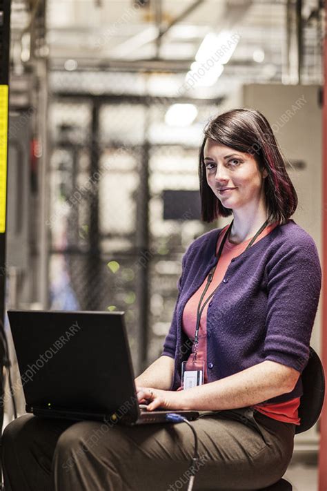 Woman Technician Working In A Large Server Farm Stock Image F021