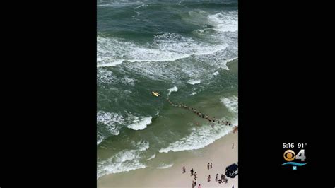 Beachgoers Form Human Chain To Rescue Bathers Caught In Rip Current